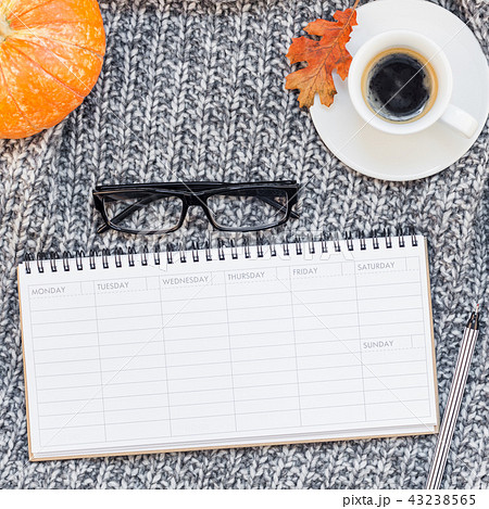 Home workplace with coffee cup on knitted plaid 43238565