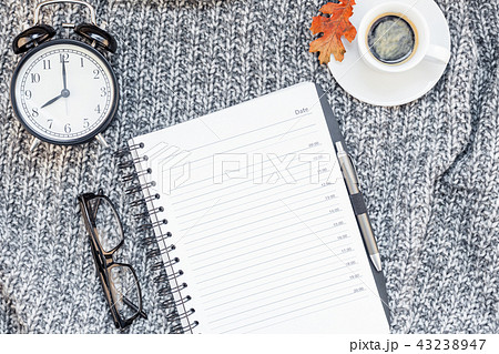 Home workplace with coffee cup on knitted plaid 43238947