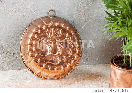 Vintage copper mold on a concrete background. Vintage copper mold on a concrete background. 43239637