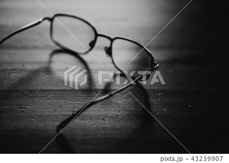 Eyeglasses on wooden table, close up photo. Black and white Eyeglasses on wooden table, close up photo. Black and white 43239907