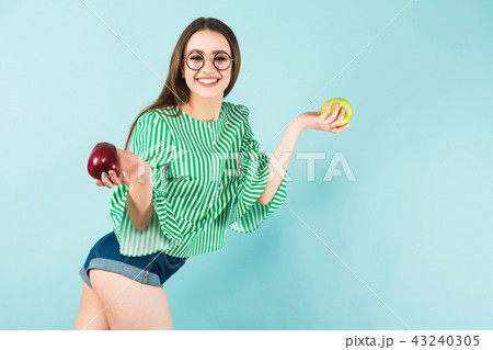 Young woman with two apples Young woman with two apples 43240305