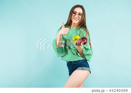 Young woman with two apples 43240309