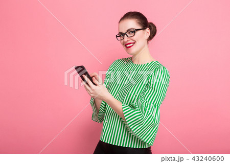 Businesswoman with hair bun and cellphone 43240600