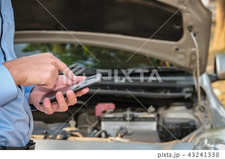 male agent use smart phone for claiming auto insurance. caucasian man calling for assistance for car broken down by traffic accident 43241338