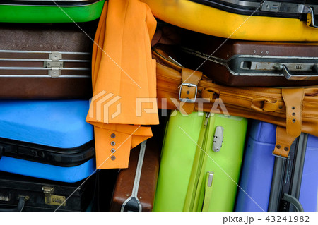 pile of luggage and baggage. old style suitcase & clothes. travel & journey concept pile of luggage and baggage. old style suitcase & clothes. travel & journey concept 43241982