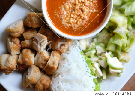 minced pork sausage, fermented rice noodle & vegetable served with chili sauce. vietnamese food called Nem Nuong Xa minced pork sausage, fermented rice noodle & vegetable served with chili sauce. vietnamese food called Nem Nuong Xa 43242461