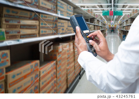 A worker scanning cargo with barcode scan. A worker scanning cargo with barcode scan. 43245761