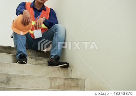 Contractor resting on stairs 43248870