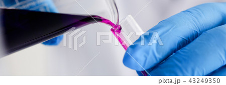 A male chemist holds test tube of glass in A male chemist holds test tube of glass in 43249350
