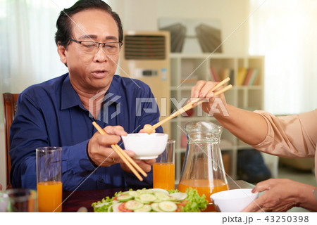 Aged man at family dinner 43250398