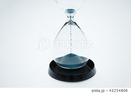 Image of hourglass with blue sand on isolated white background 43254806
