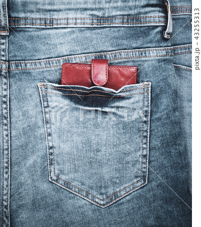 purse lies in the back pocket of blue jeans purse lies in the back pocket of blue jeans 43255313