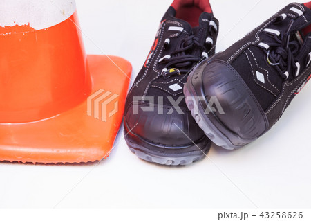 work shoes and a safety cone work shoes and a safety cone 43258626