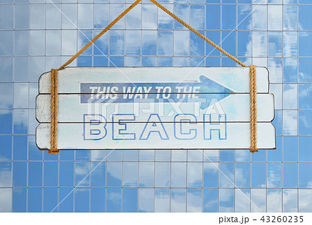 Way to beach sign over glass office building Way to beach sign over glass office building 43260235