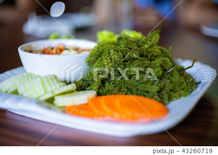 Thai spicy papaya salad with seaweed caviar  43260719