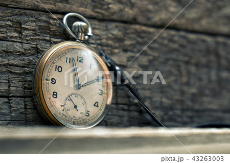 Shabby vintage swiss pocket watch on the wooden boards 43263003