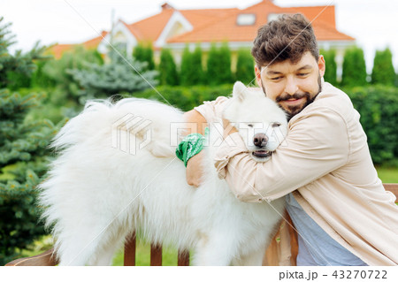 Handsome man and white husky enjoying freshness of summer day 43270722