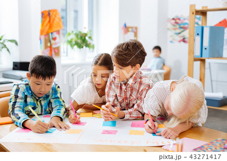 Cute kids drawing a new poster in a classroom 43271417