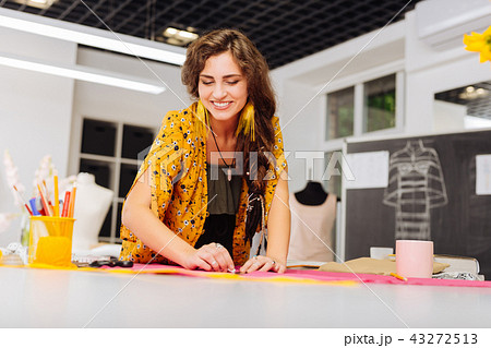 Enthusiastic woman feeling good and smiling while working in atelier 43272513