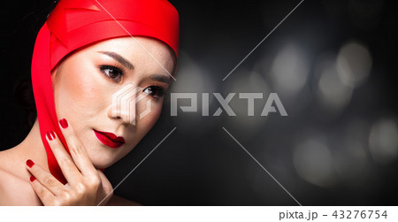 Asian tanned skin woman with strong color red lips Asian tanned skin woman with strong color red lips 43276754