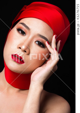 Asian tanned skin woman with strong color red lips 43276755