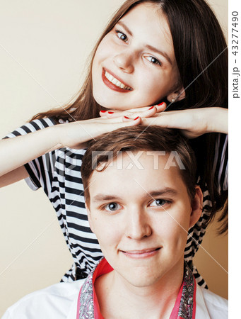 couple of happy smiling teenagers students, warm colors having a couple of happy smiling teenagers students, warm colors having a 43277490