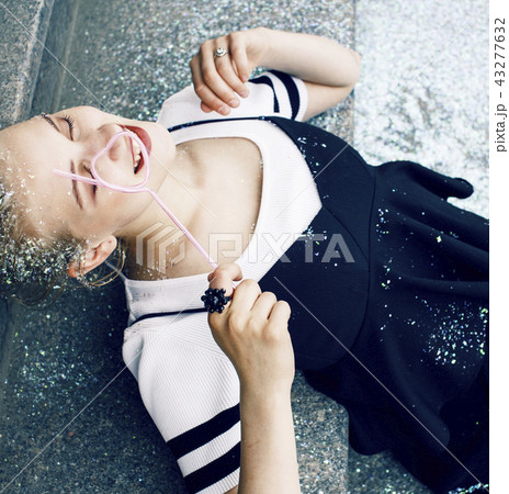 young pretty party girl smiling covered with glitter tinsel, fas 43277632