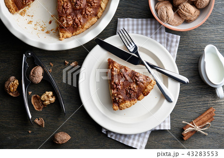 Traditional walnut pie with spices and nuts on dark wooden table 43283553