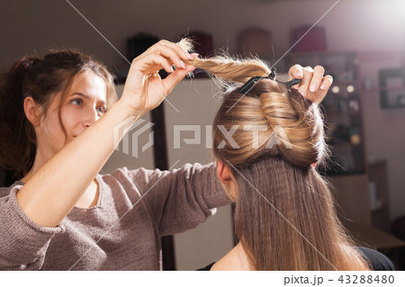 hairdresser making a coiffure to a model 43288480