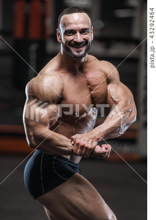 strong bodybuilder athletic men pumping up muscles strong bodybuilder athletic men pumping up muscles 43292464