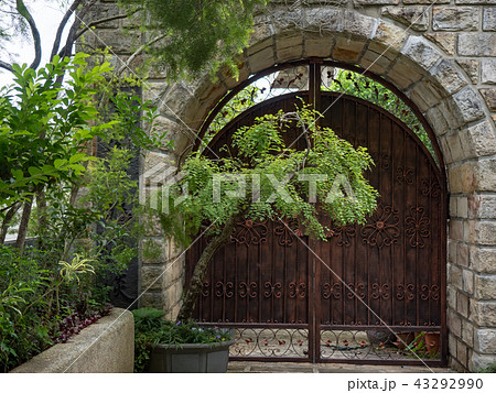 Stone wall with an old door 43292990