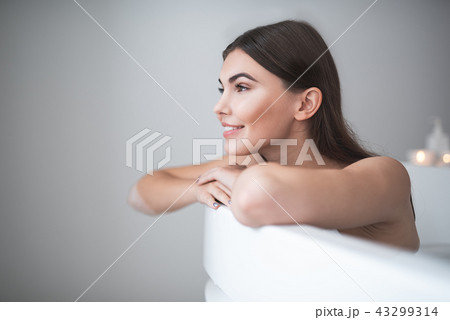 Cheerful girl having leisure in cozy bathroom Cheerful girl having leisure in cozy bathroom 43299314