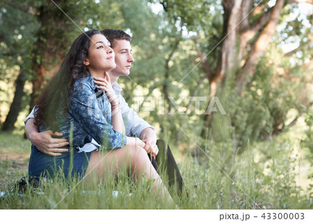 young couple walking in the forest, romantic  43300003