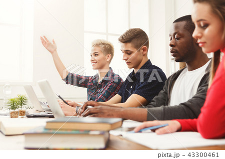 Group of diverse students studying at wooden table Group of diverse students studying at wooden table 43300461