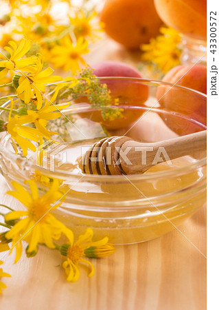Honey stick and a glass jar 43300572