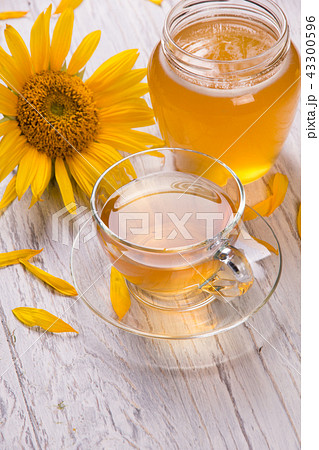 Cup of tea and honey in a glass jar Cup of tea and honey in a glass jar 43300596