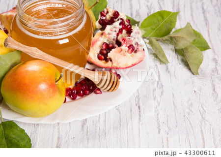 Pieces ripe pomegranate, honey and apple Pieces ripe pomegranate, honey and apple 43300611