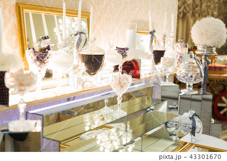 Delicious and tasty dessert table with cupcakes shots at reception closeup 43301670