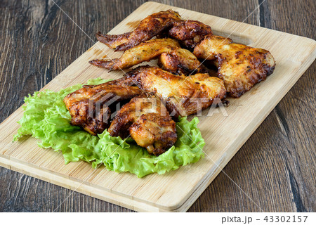 Hot and spicy buffalo chicken wings on cutting board Hot and spicy buffalo chicken wings on cutting board 43302157