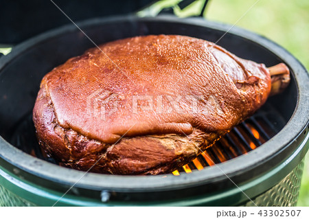 Grilled and smoked pork meat on professional grill Grilled and smoked pork meat on professional grill 43302507
