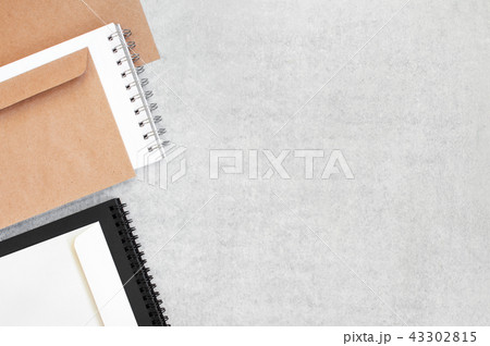 Grey background with blank notepads and envelopes 43302815