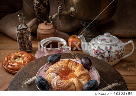 Breakfast with a samovar. Tea and cheesecake with jam Breakfast with a samovar. Tea and cheesecake with jam 43303394