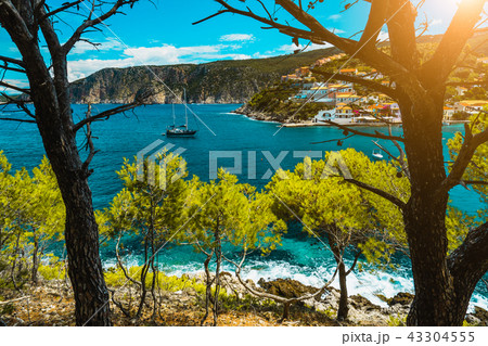 Beautiful bay with picturesque sea water surrounded by pine trees. Assos village Mediterranean Sea Beautiful bay with picturesque sea water surrounded by pine trees. Assos village Mediterranean Sea 43304555