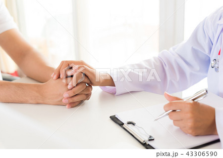 Doctor holding patient's hand.  43306590