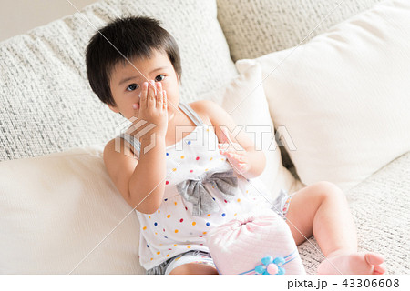 Asian girl wiping or cleaning nose with tissue Asian girl wiping or cleaning nose with tissue 43306608