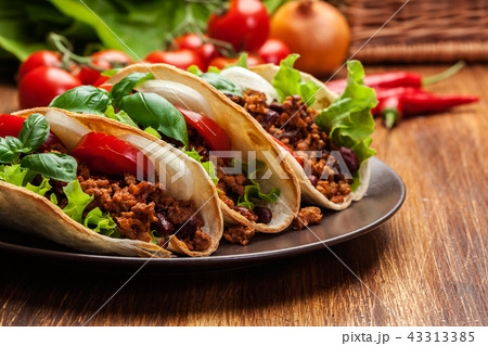 Mexican tacos with minced meat, beans and spices 43313385