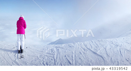 Woman skier in pink ski jacket 43319542