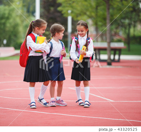 Happy children girlfriend schoolgirl student elementary school Happy children girlfriend schoolgirl student elementary school 43320525