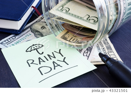 Rainy day fund savings. Jar with dollar bills. 43321501