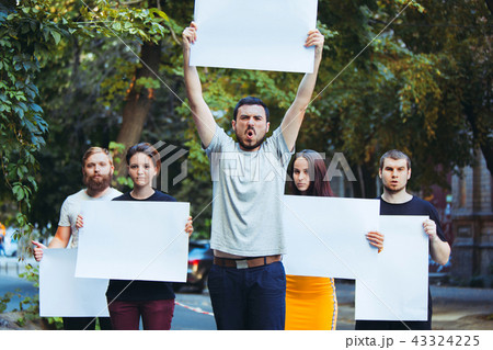 Group of protesting young people outdoors Group of protesting young people outdoors 43324225